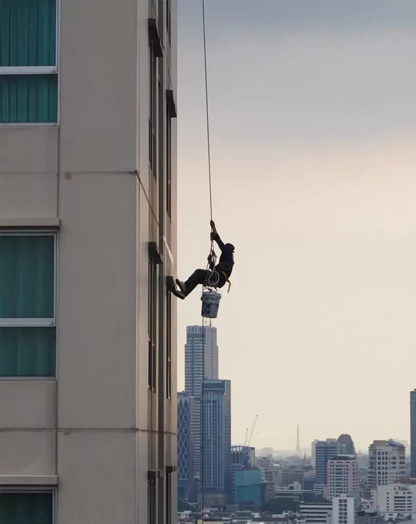 Cleaning Manpower - Person using rope to clean windows